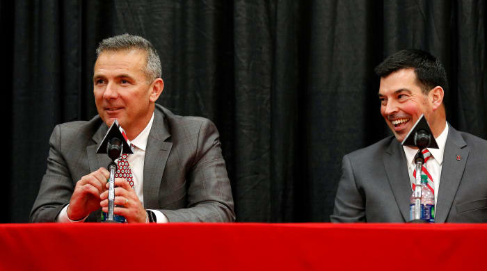 Former Ohio State coach Urban Meyer and current coach Ryan Day speak at a press conference.